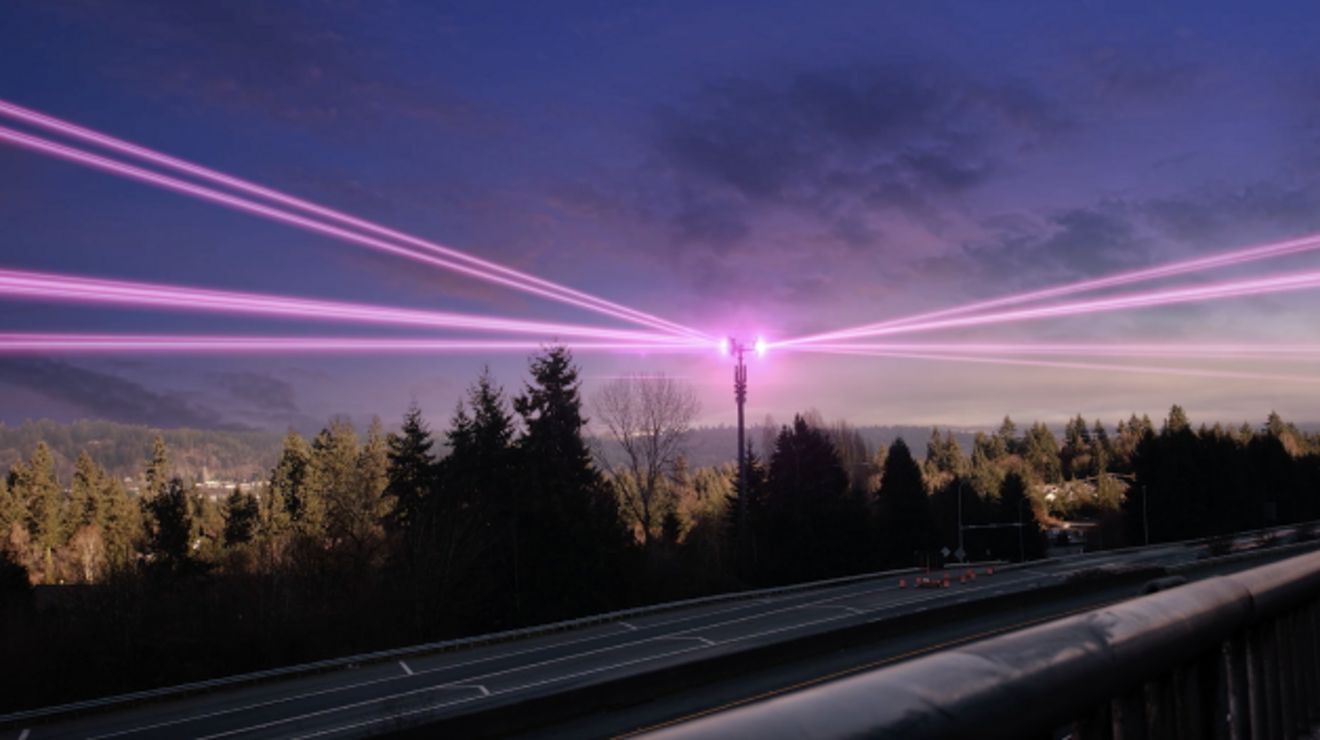 Magenta beams coming from a tower.