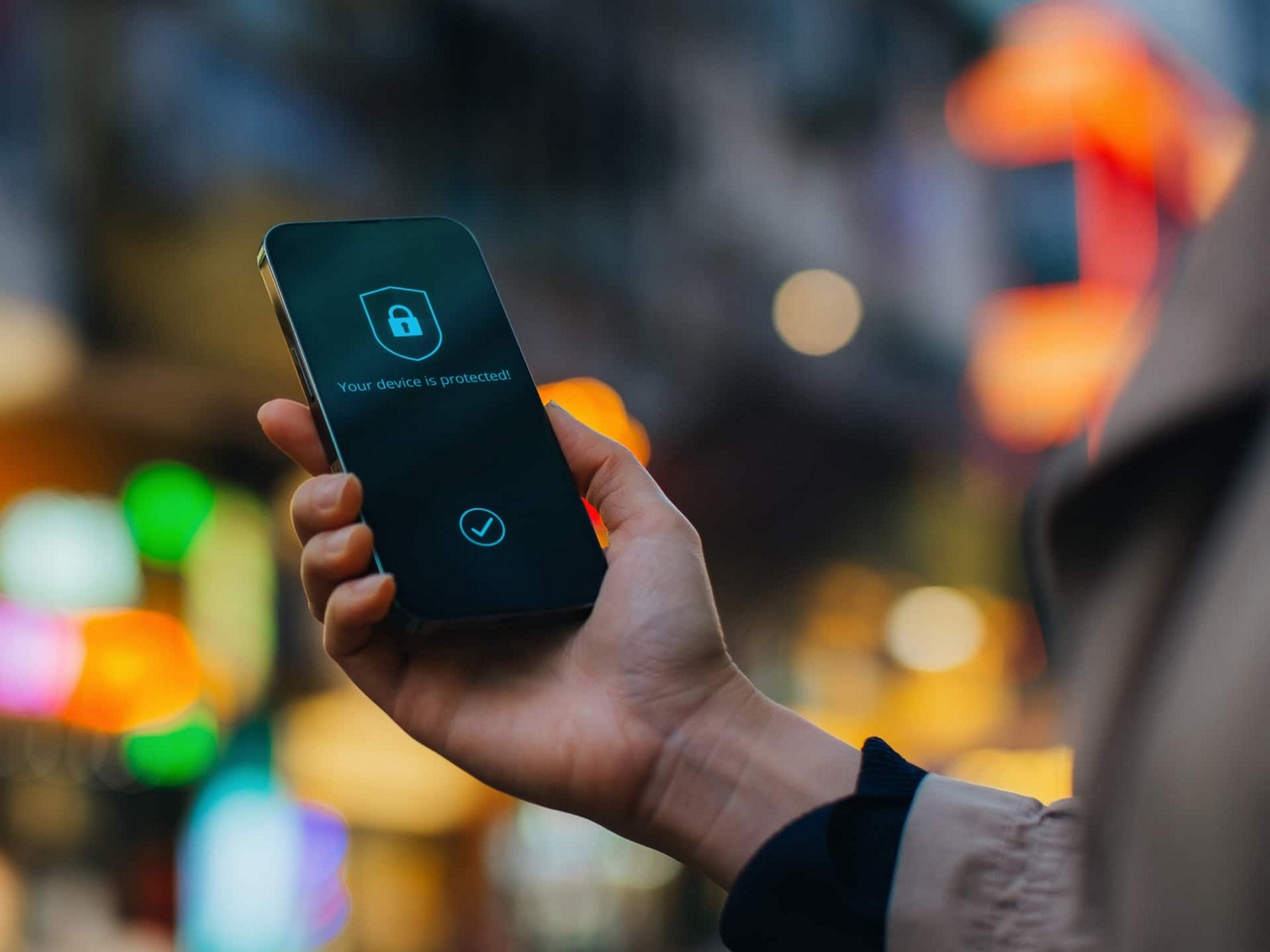 Close-up of a smartphone screen displaying a message that reads “Your device is protected.”
