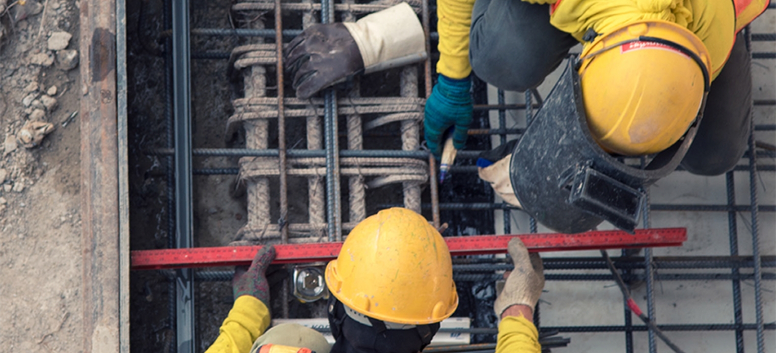 Food server carries a plate of food out of a restaurant kitchen.