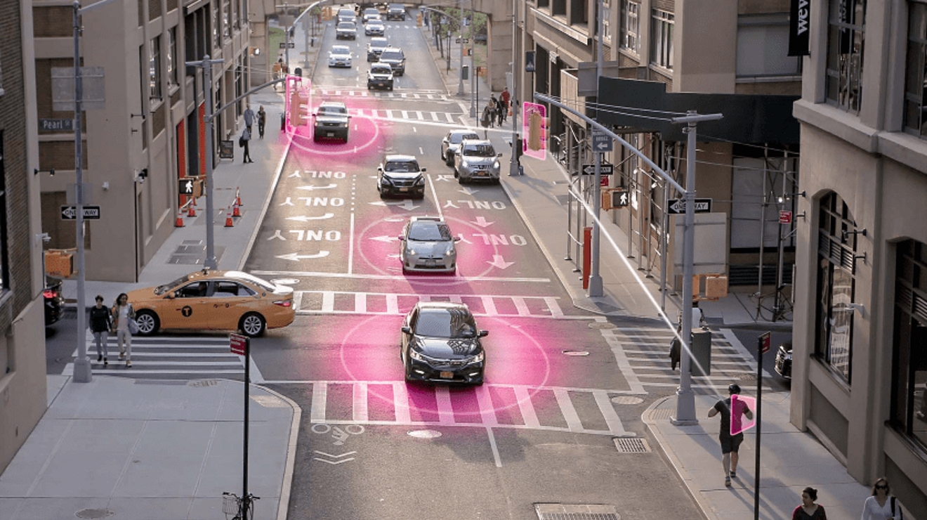 Overhead view of connected cars and stoplights in an intersection in Dumbo, Brooklyn, New York City.