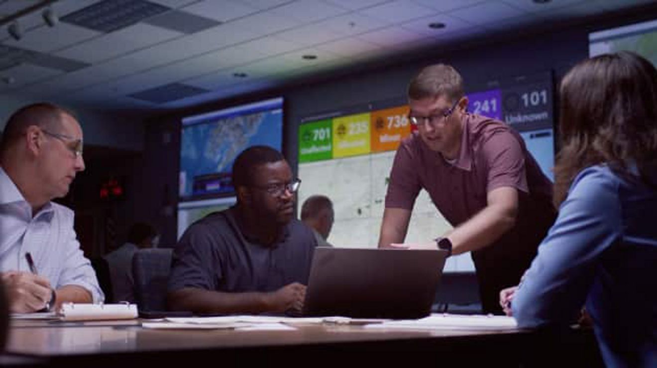 Emergency responder team around a laptop