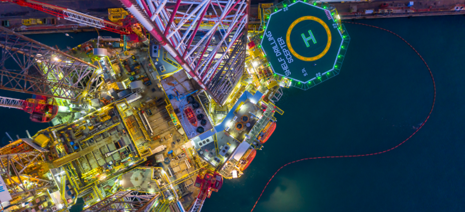 Aerial view of an offshore oil rig at night.