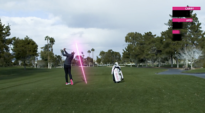 A golfer completes his swing next to his T-Mobile golf bag; while the the path of the ball is tracked in magenta.