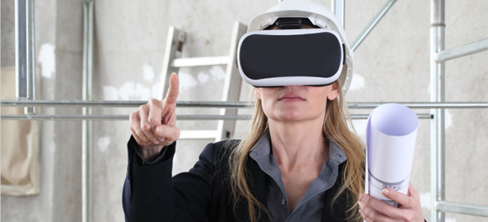 Woman wearing VR glasses gestures into the air with one hand while holding blueprints in the other.