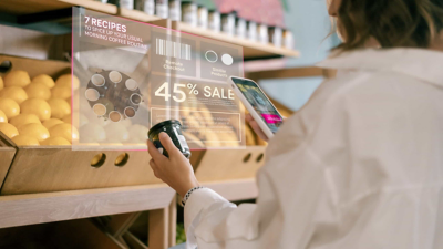 A supermarket shopper scans a jar for product information and recipes. 