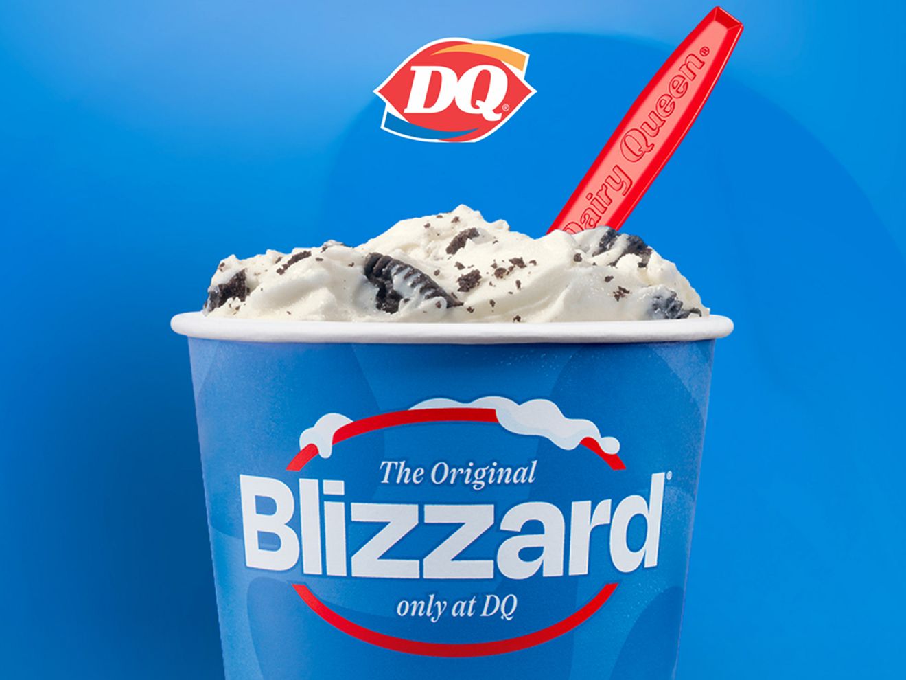 The original Mini Blizzard Treat—soft-serve blended with chocolate cookies in a bright blue cup with a red spoon—only at DQ.