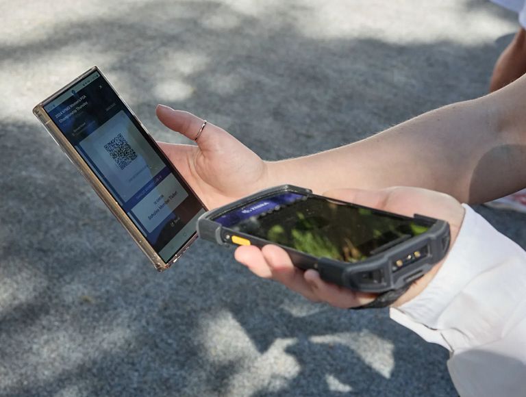 Close-up of a mobile ticket being scanned. 