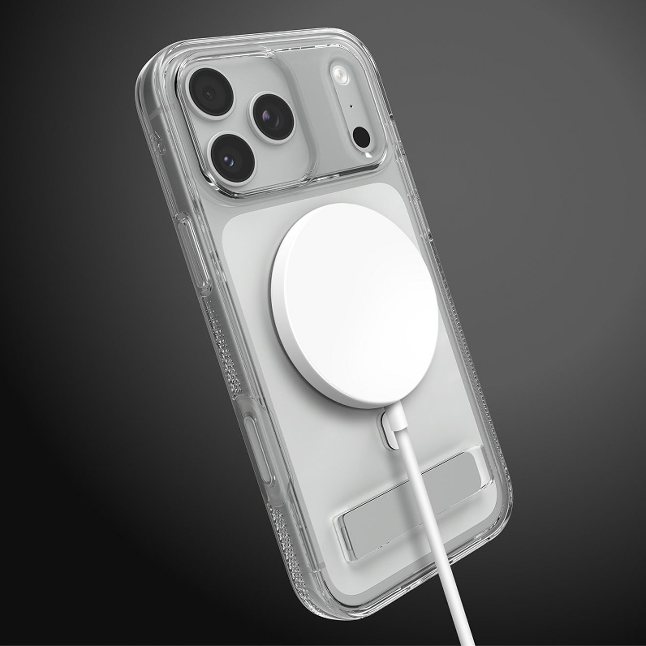 A silver iPhone 17 Pro in a clear ZAGG case with a built-in kickstand charges with a white MagSafe charger attached to the back.