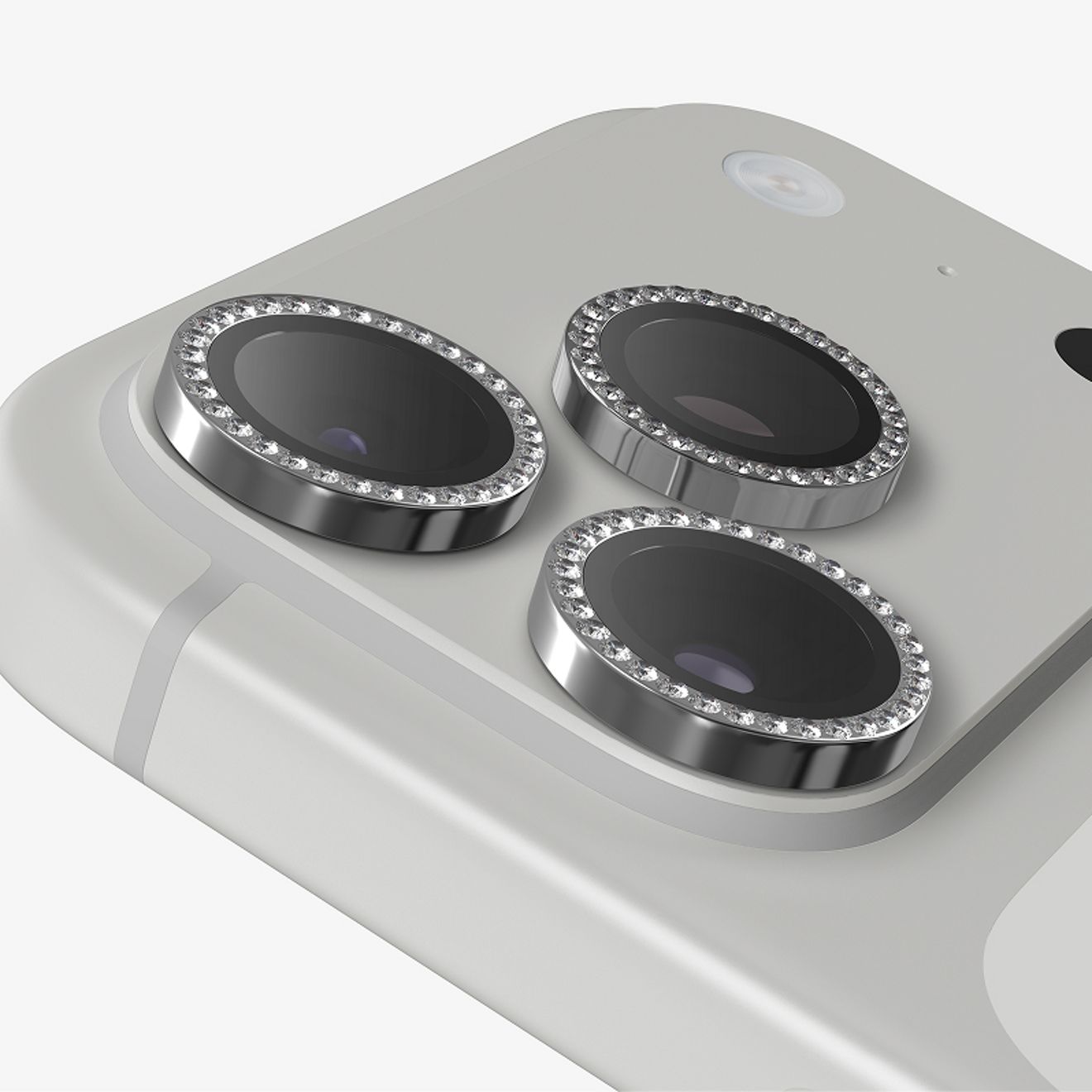 Close-up of three silver ZAGG Glass Elite Camera Lens Protectors with Diamond detailing fitted securely over the rear camera lenses of a silver iPhone Pro.