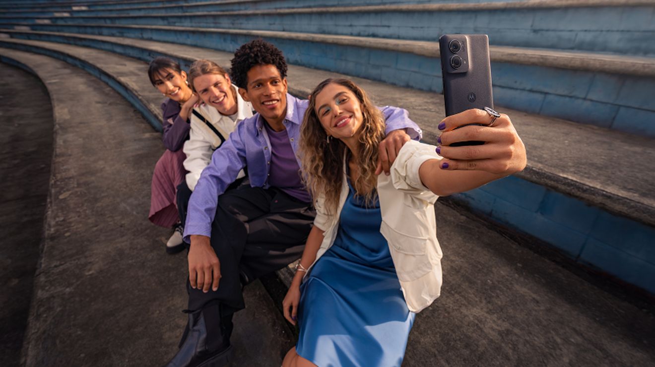 A small group of friends taking a selfie with their smartphone.