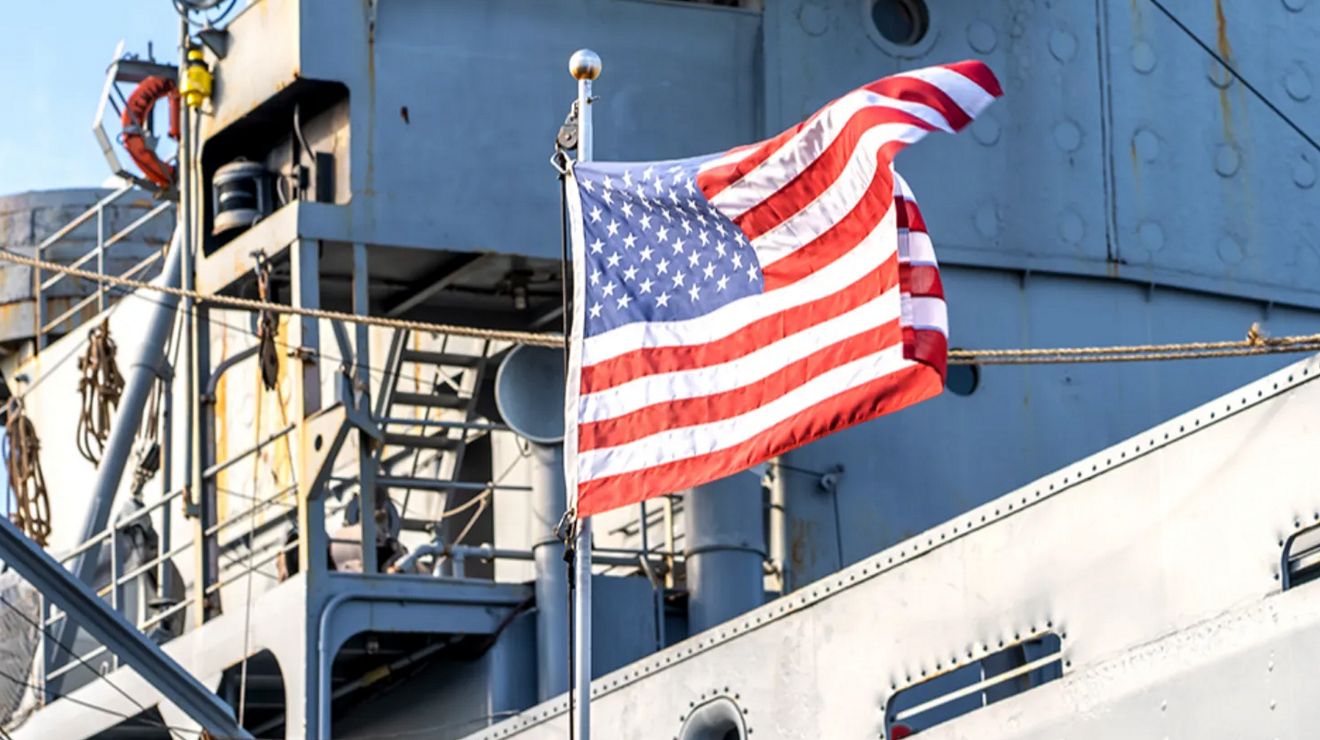 American flag waving on a U.S. Navy ship.