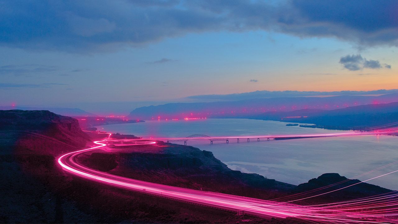 Landscape with magenta beams lighting up roads and bridges