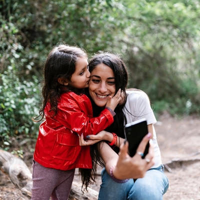 Little girl kissing mother on head