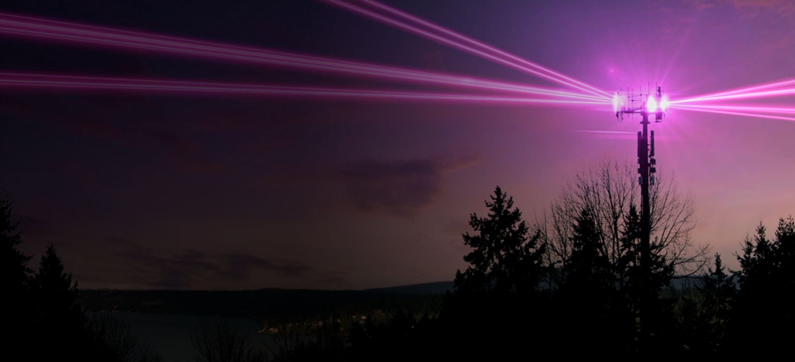 Magenta lights emanating from a cell tower. 