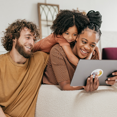 Family smiling at a tablet