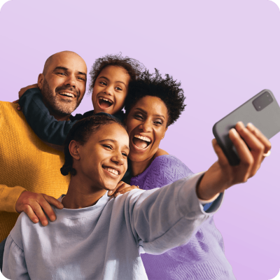 Family of four taking a selfie.