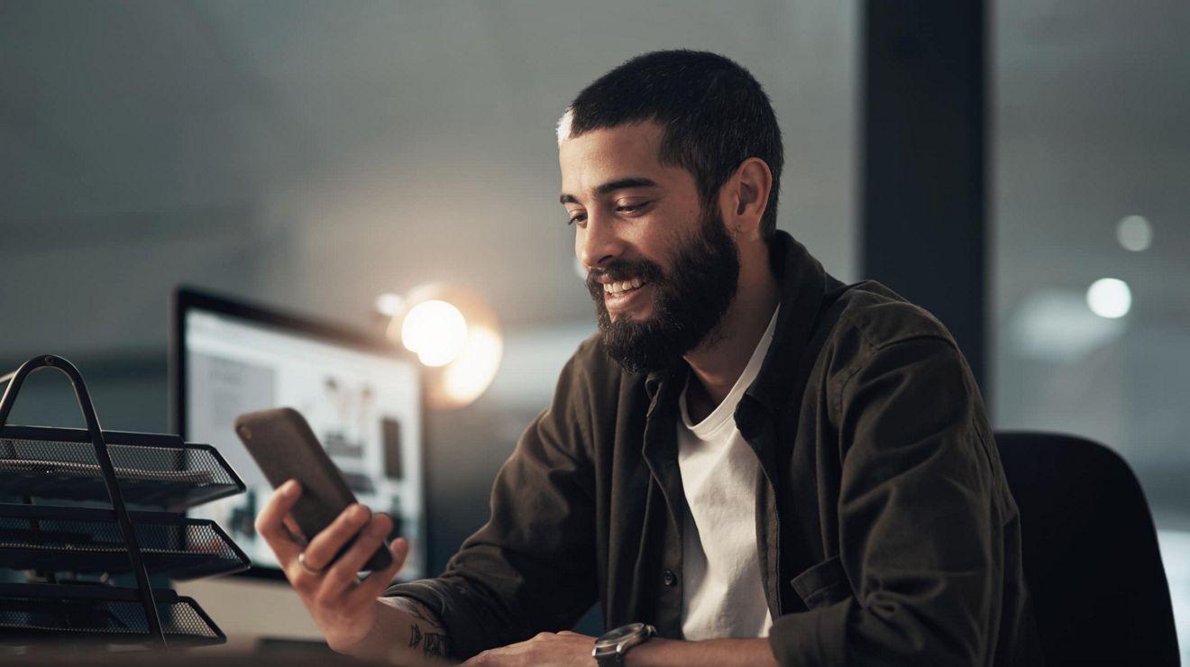 A AAA partner reviews client information on a connected mobile phone. 