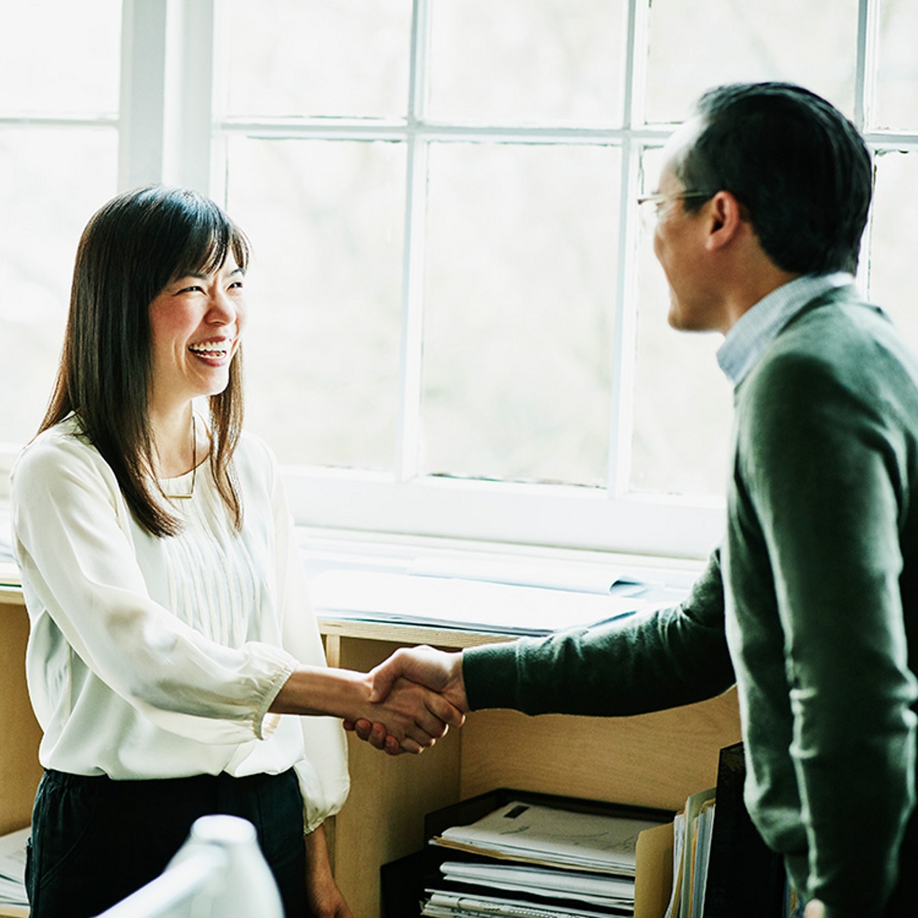 Two business people shaking hands.