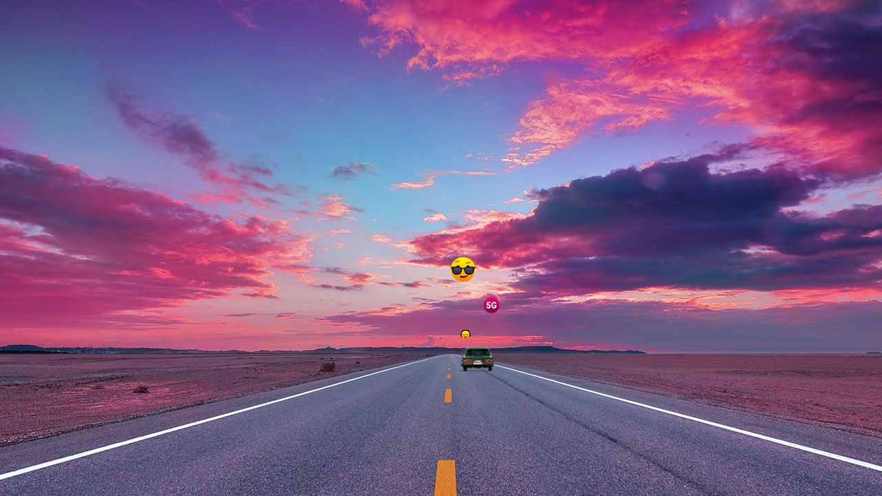 Car driving down an empty highway road in the desert at sunset.