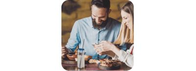 A couple at a restaurant enjoying dinner.