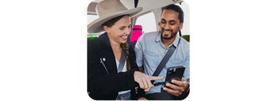 A couple smiling and about the trip they just won.