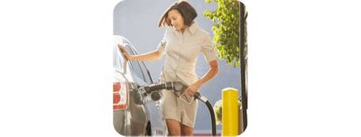 Lady smiling and pumping gas.