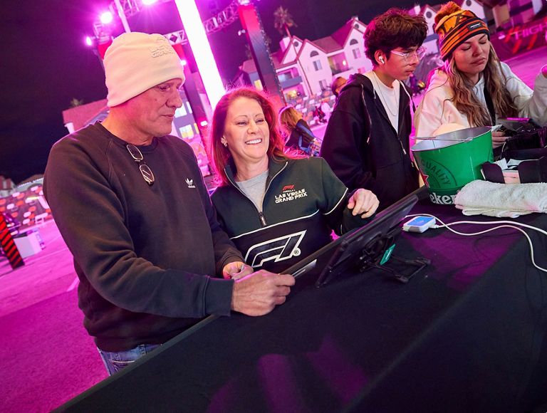 An F1 fan making a contactless credit card payment at a concession stand.