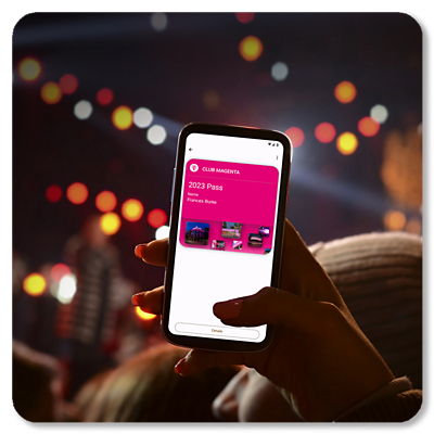 A phone getting lifted with Club Magenta on the screen; with a live event in the background.