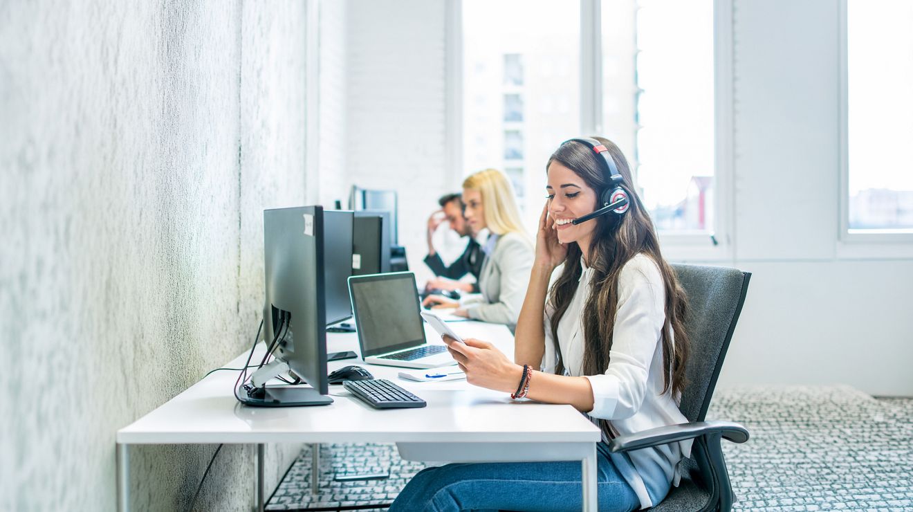 A customer service associate confidently assists a client using relevant suggestions from built-in AI.