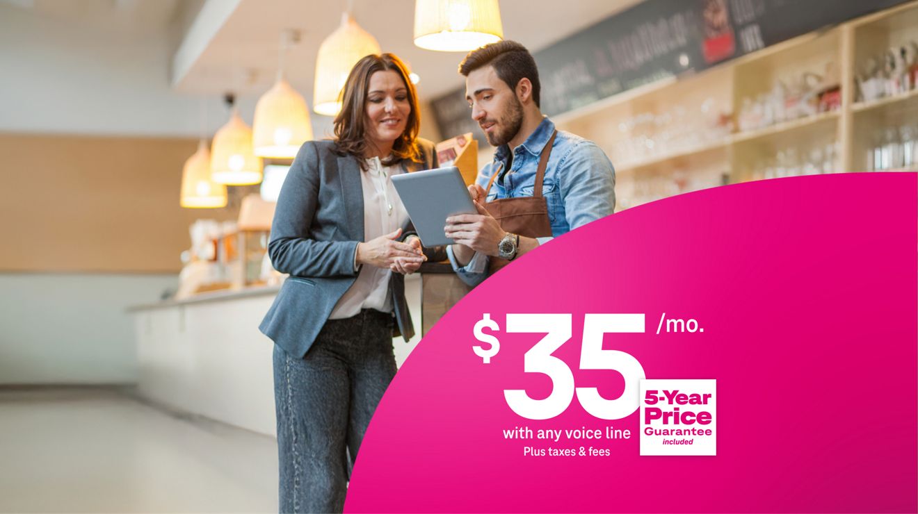 Two small-business professionals looking at a tablet; $35 per month with any voice line, plus taxes and fees, with a 5-year price guarantee included.
