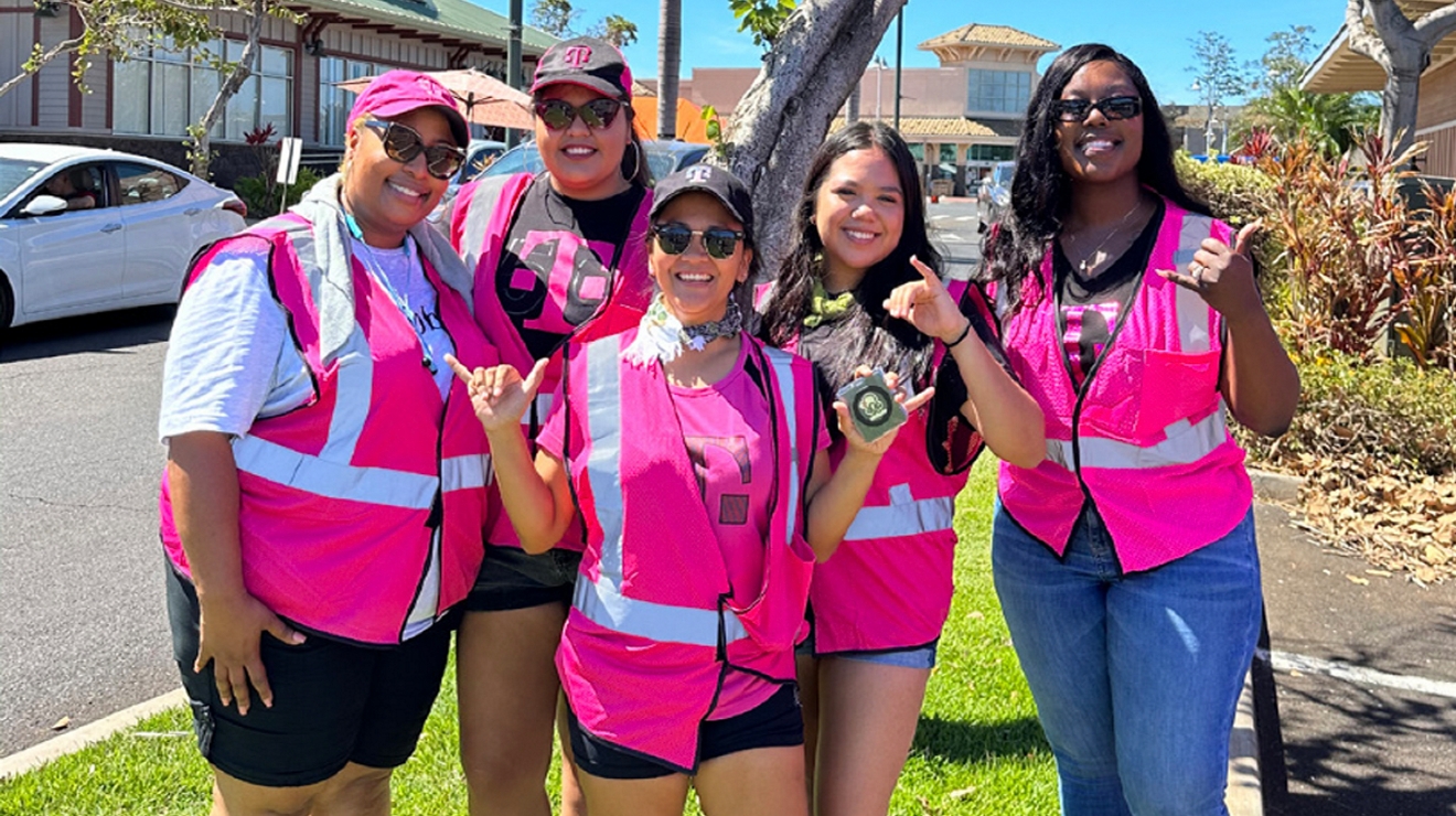A group of T-Mobile employees posing for a picture outside