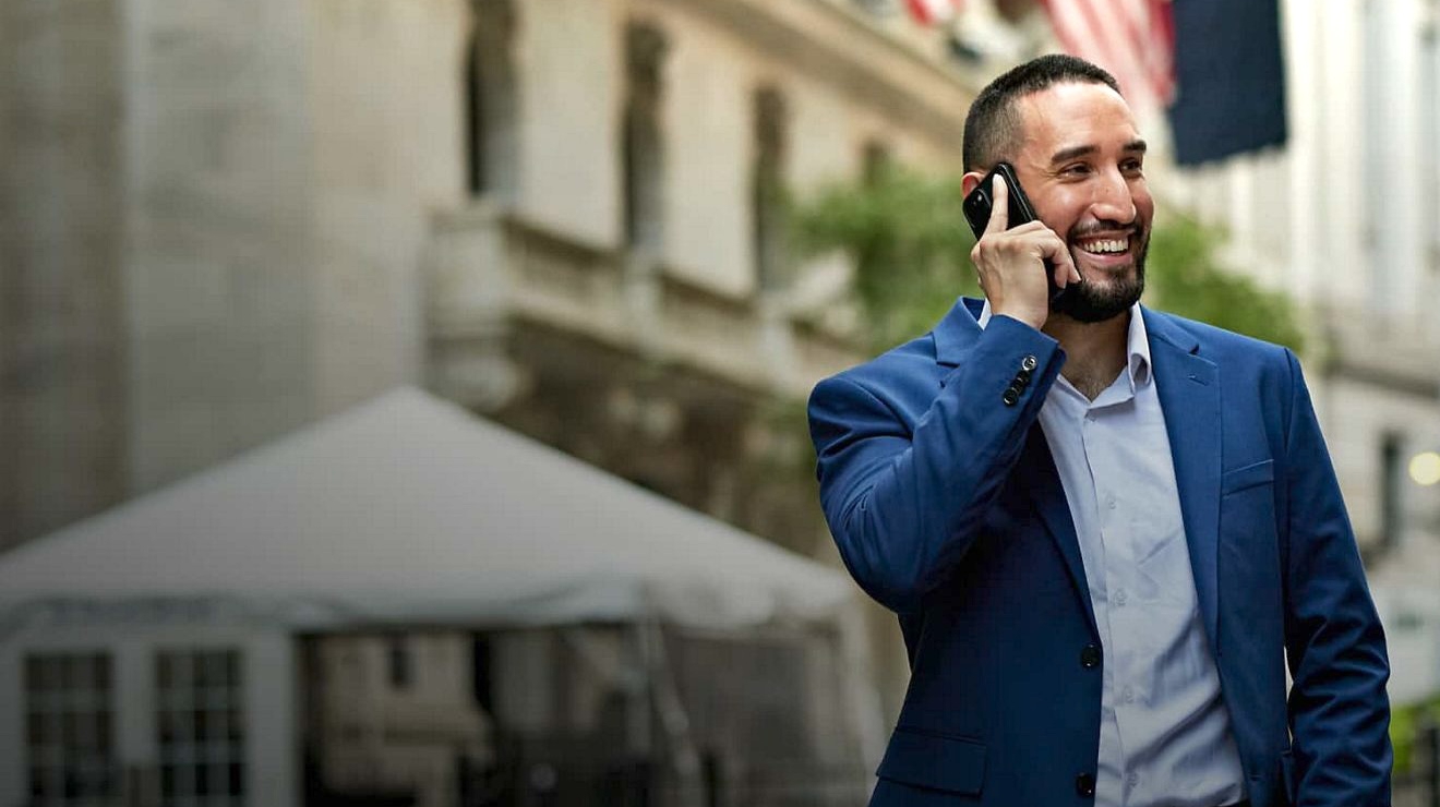 An EMT near an ambulance uses a tablet enabled with Direct Connect, a push-to-talk service.