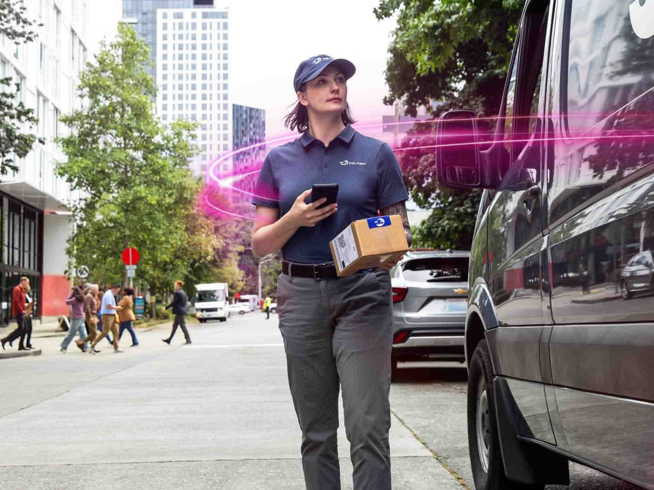 A delivery driver scans a package using a smartphone outside a modern office building.