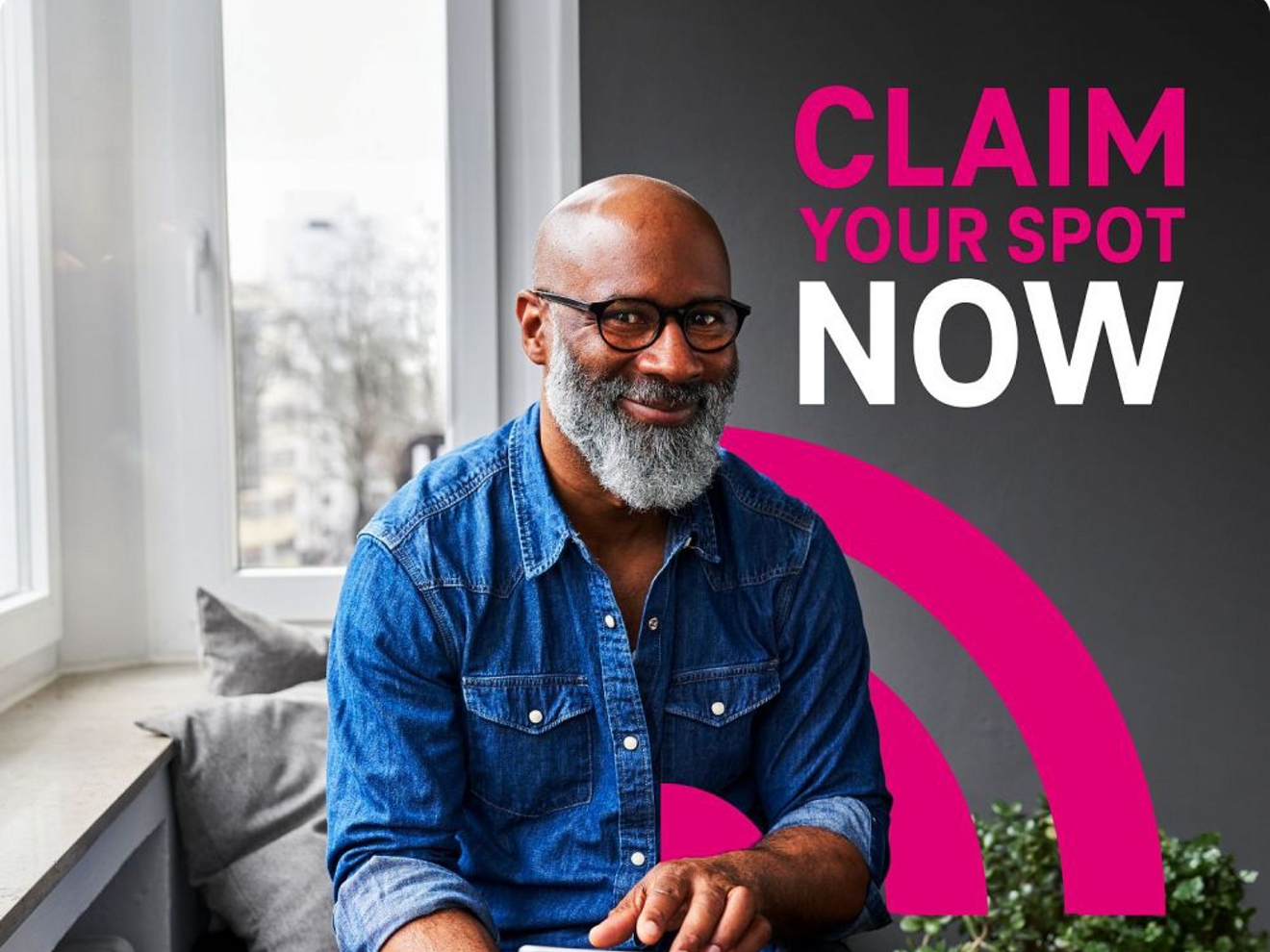 Person with glasses smiling while he hold a tablet