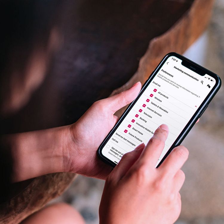 Person entering personal information into their mobile device.