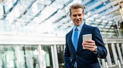 An EMT near an ambulance uses a tablet enabled with Direct Connect, a push-to-talk service.