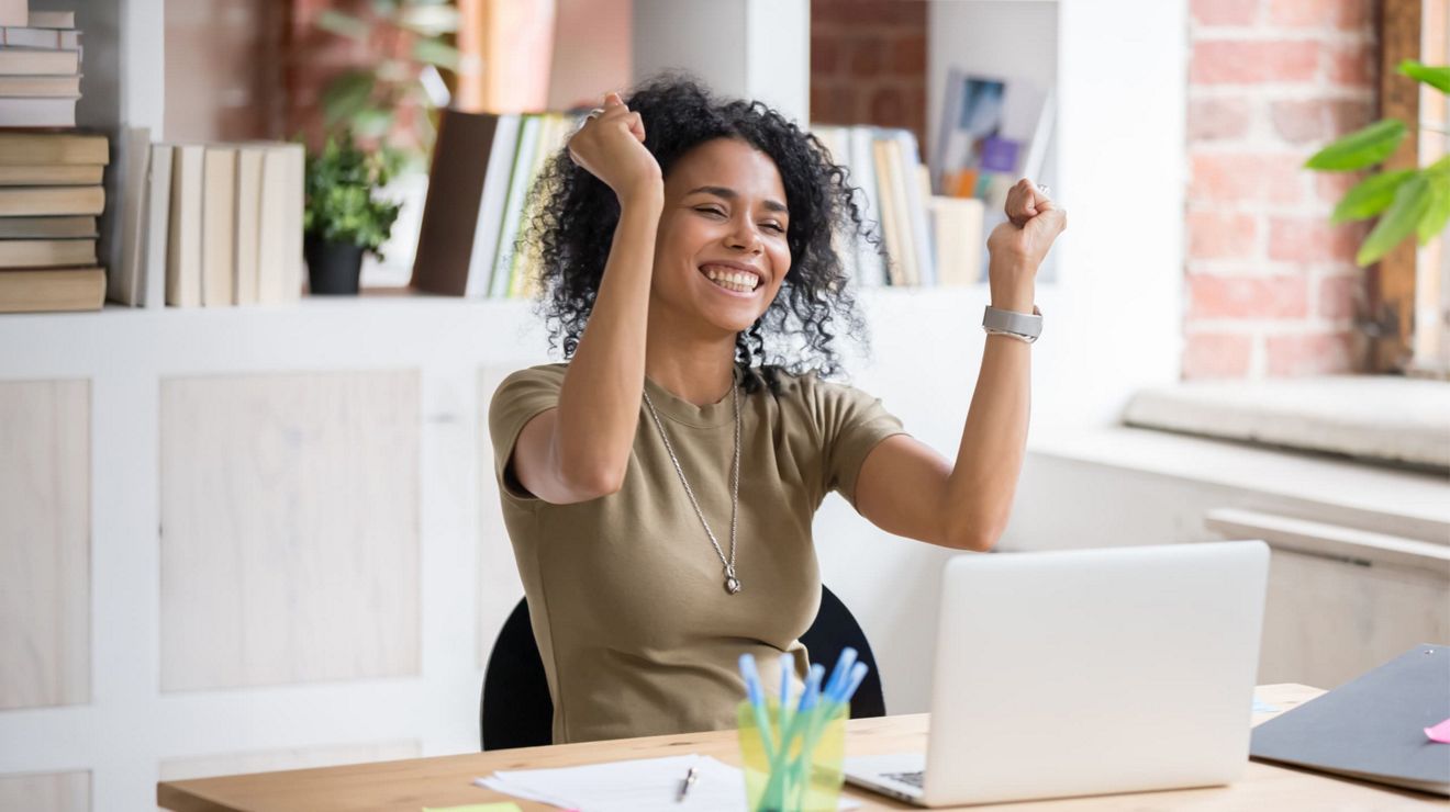 A businessperson in a home office reacts excitedly after learning about perks through T-Mobile.