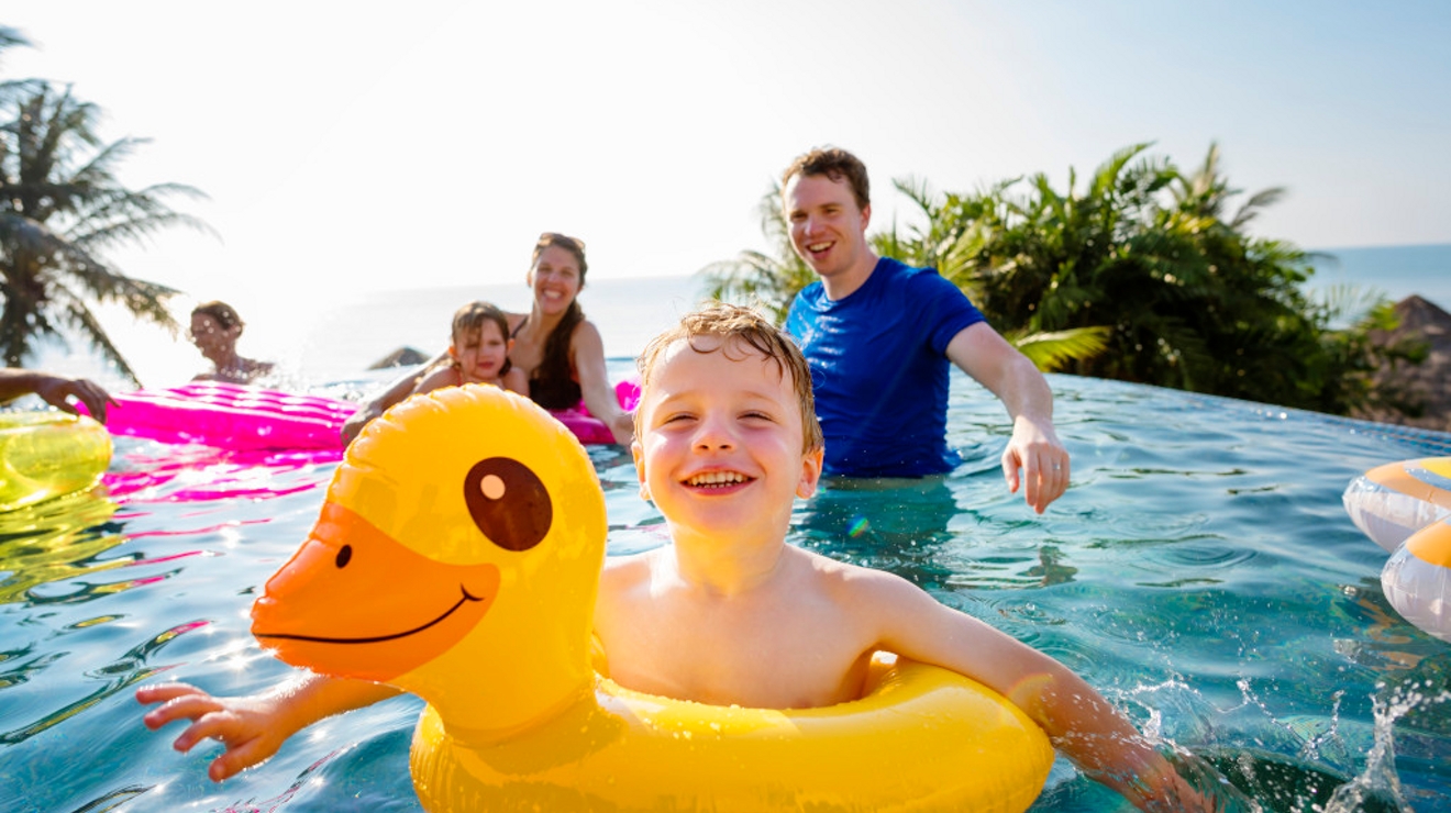 Family playing in a pool
