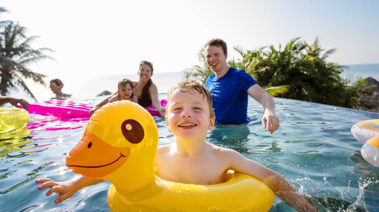 Family playing in a pool