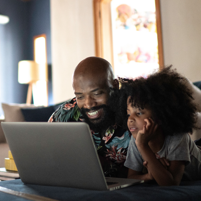Father and daughter looking at laptop
