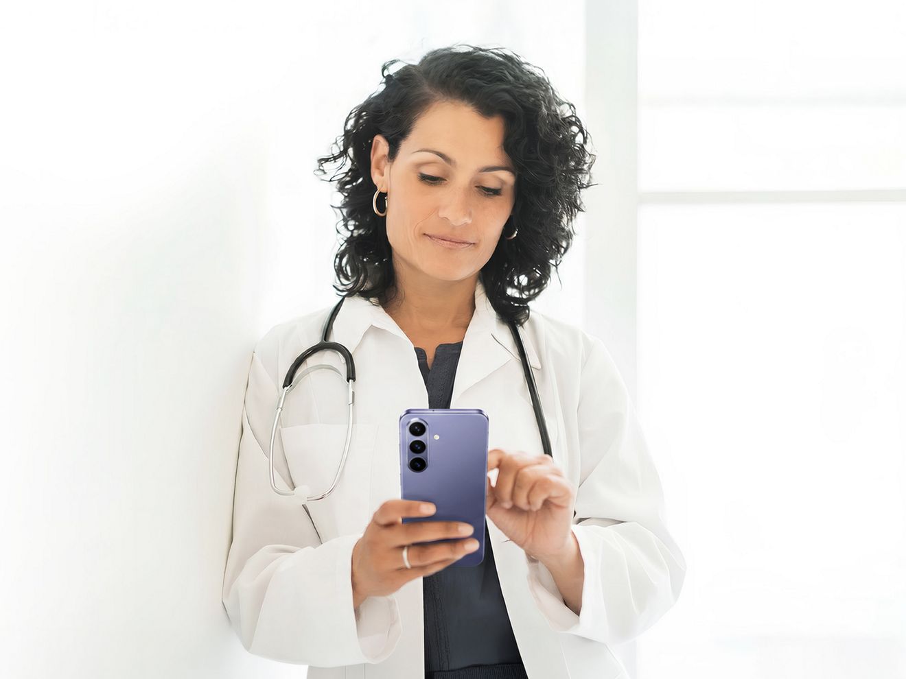 A clinician uses a Samsung Galaxy S26 Ultra on T-Mobile to connect with colleagues and patients.