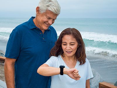 A senior couple looking at a smartwatch