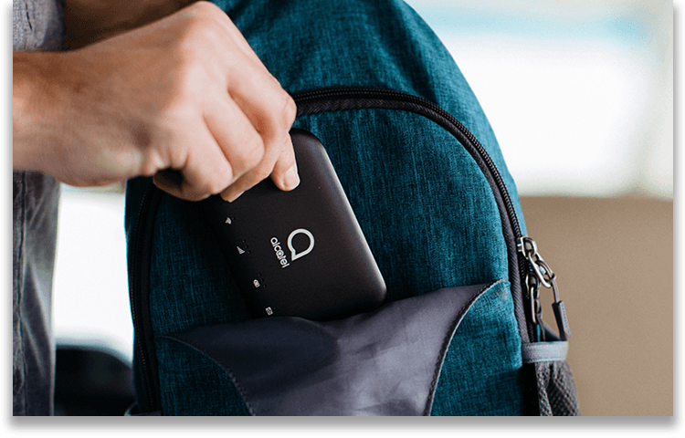 Man takes a portable hotspot device out of a backpack.