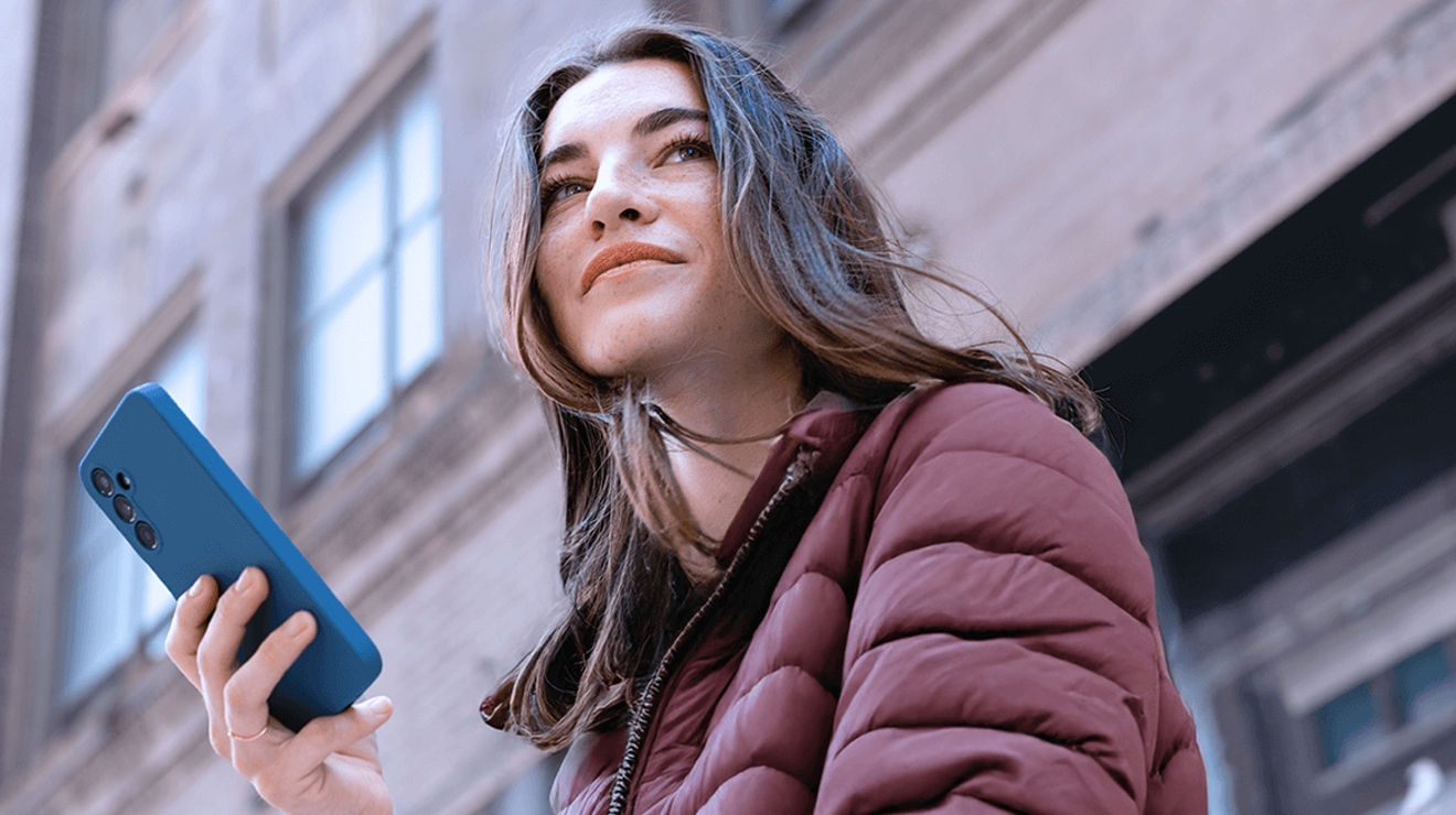 A woman looks at her smartphone. 