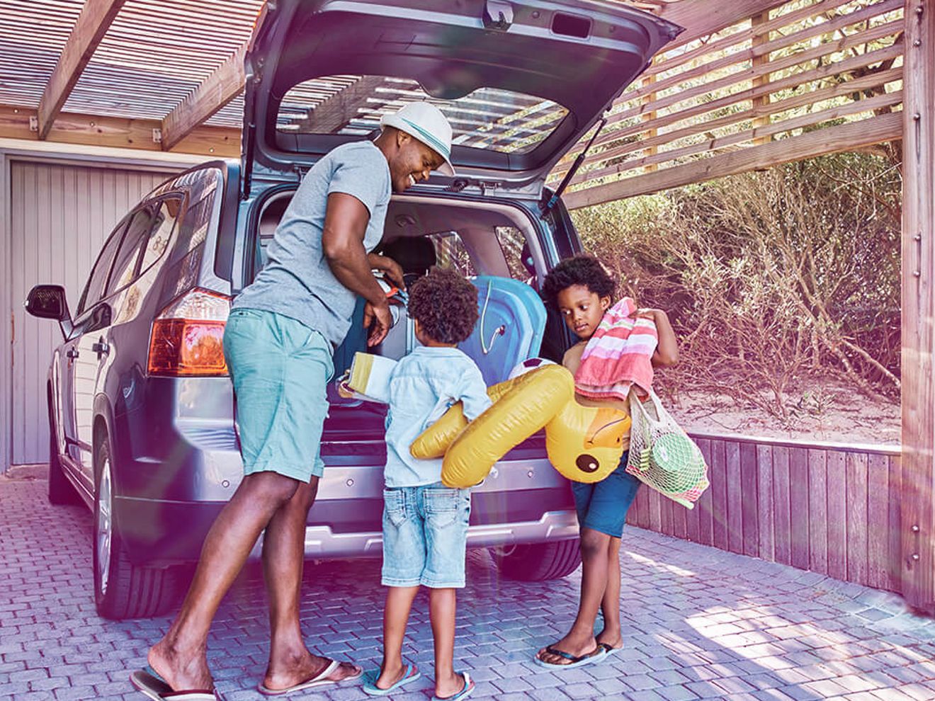A family packing the trunk of their car for a vacation. 