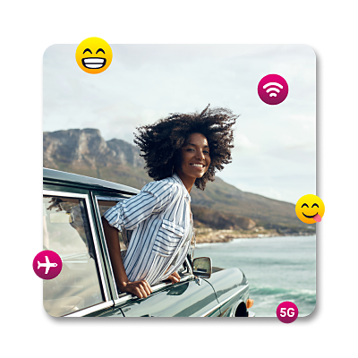 Woman smiling with her head out of a car with emojis floating