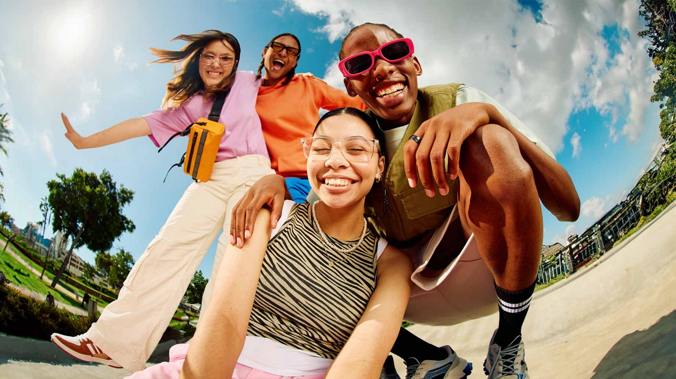 Image of a young friends taking a selfie with a park in the background
