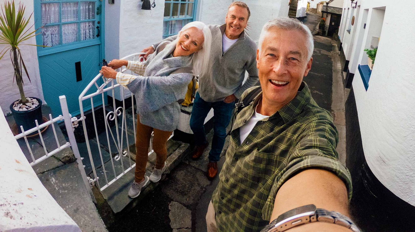 Image of two men and a woman taking a selfie in the ally way