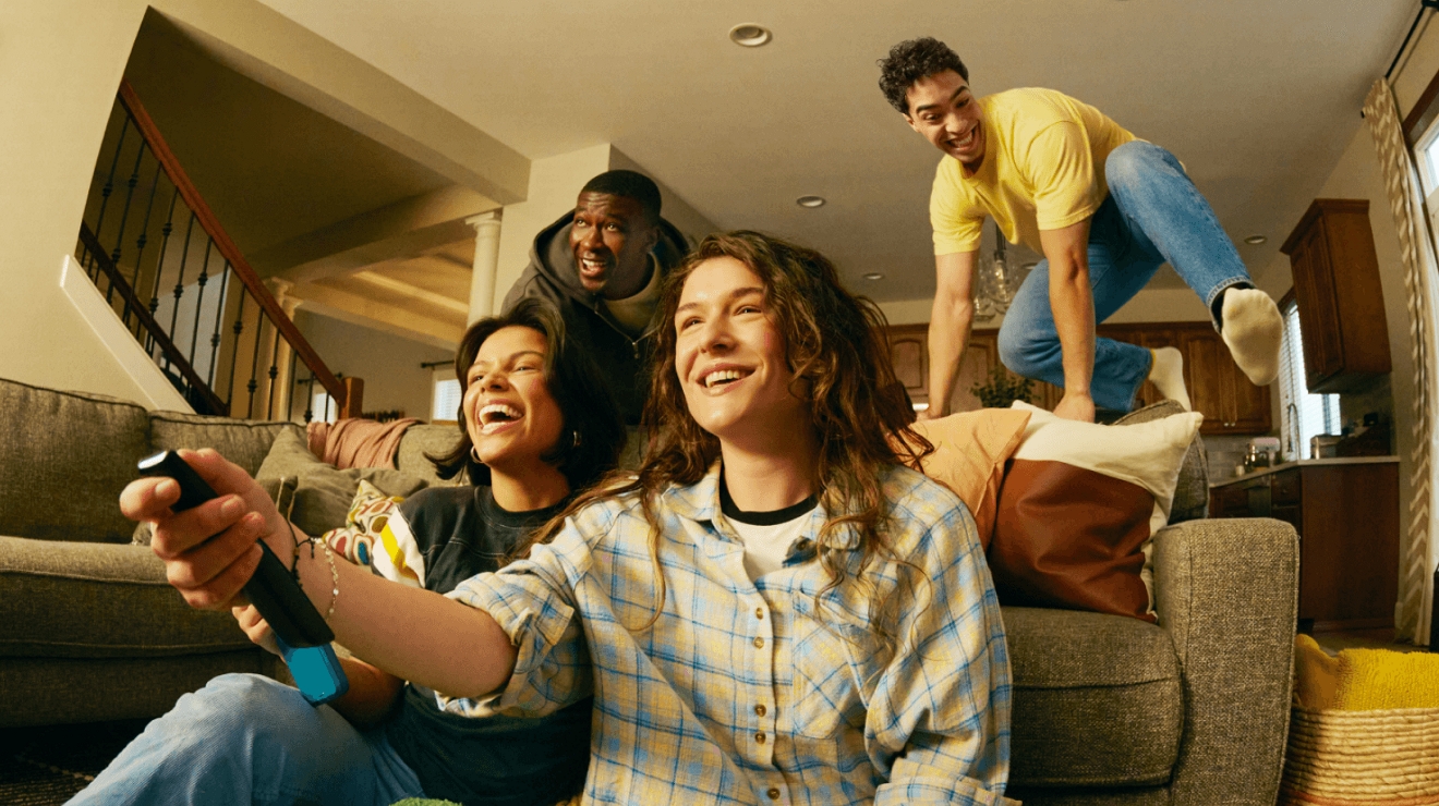 A person holds their 5G-connected smartphone and walks outside wearing augmented reality glasses.