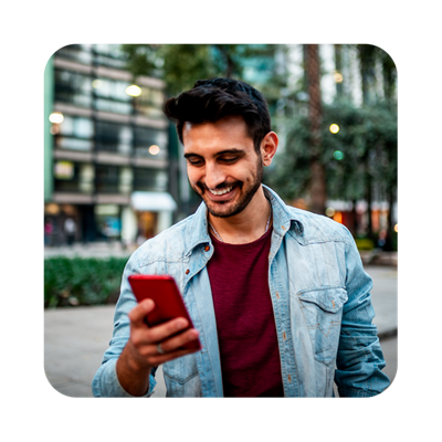 Man looking at his phone and smiling.